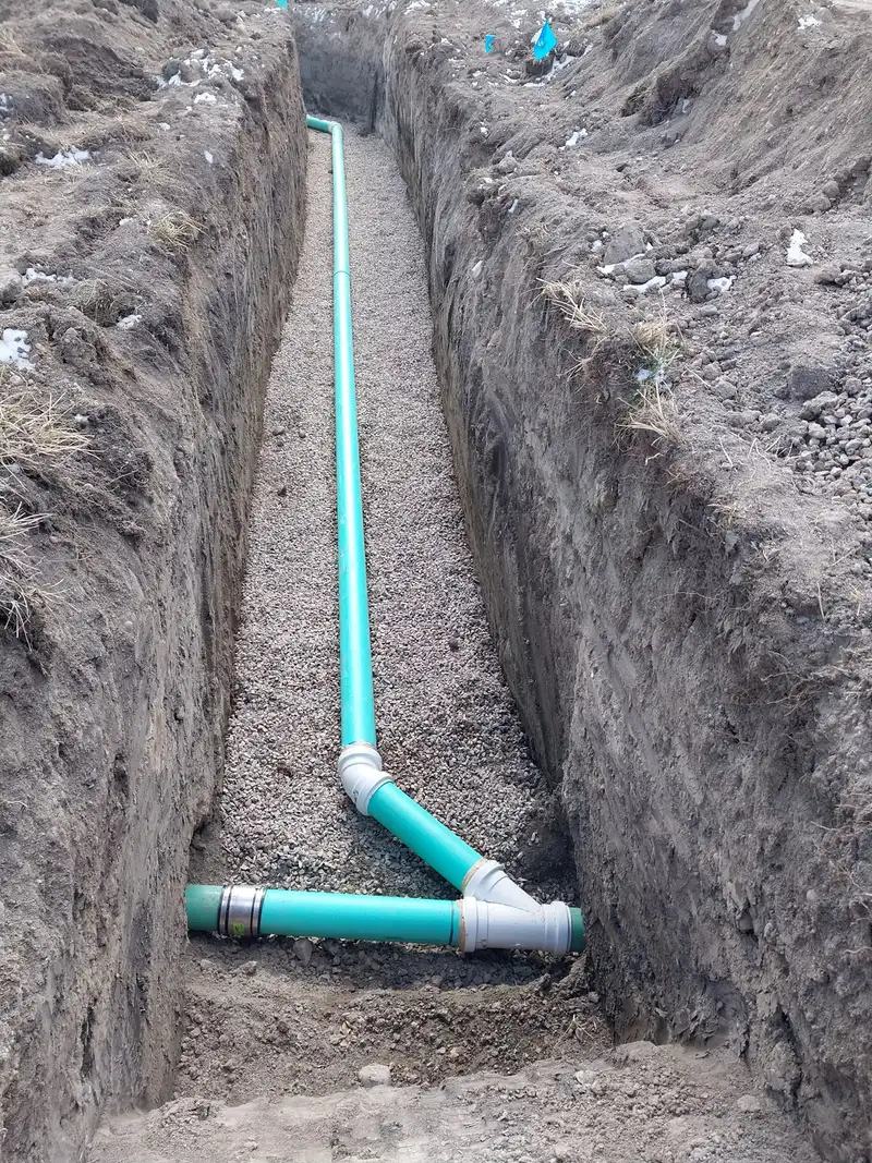 New sewer line with a wye fitting laid in a trench