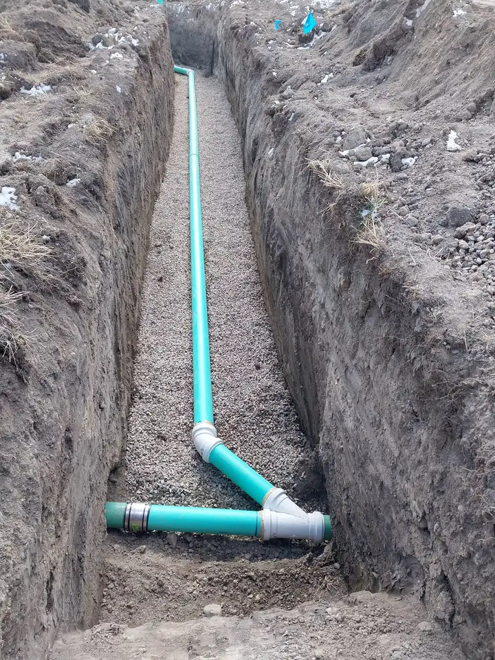 New sewer line with a wye fitting laid in a trench