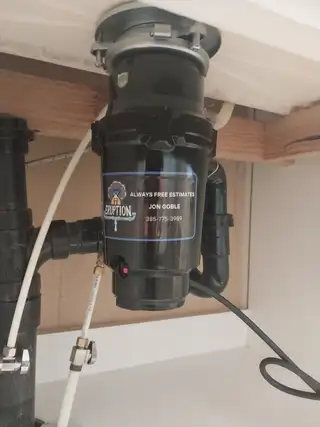 New garbage disposal installed under a sink