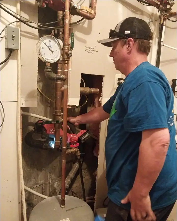 Plumber replacing copper piping on a boiler and water heating system