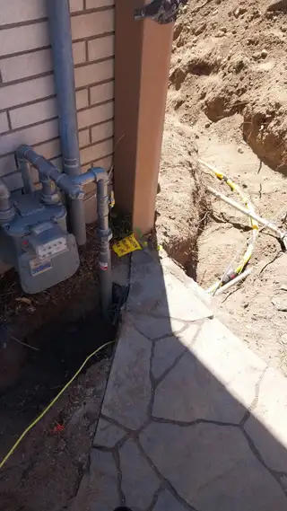 Gas meter tie-in with a yellow gas line in an open trench